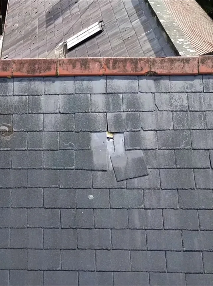 Slate roof with slipped and patch-repaired slates