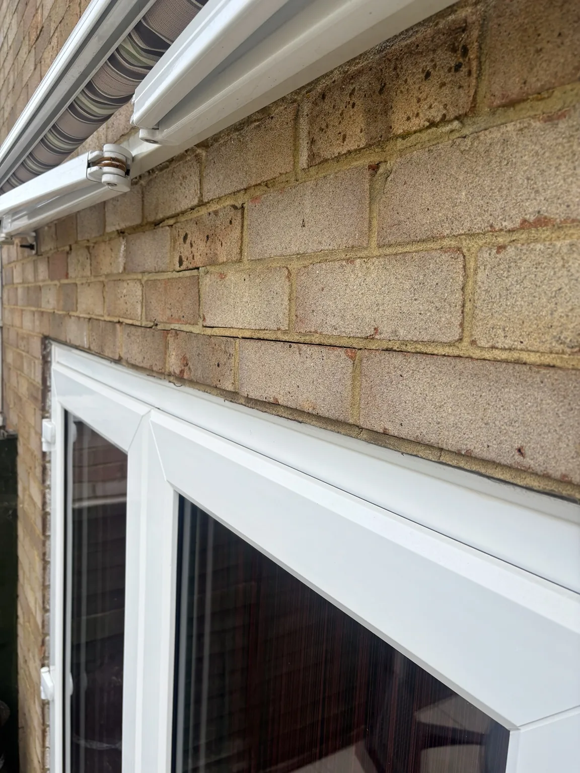 Close view showing open horizontal mortar joint and deflection above a door opening