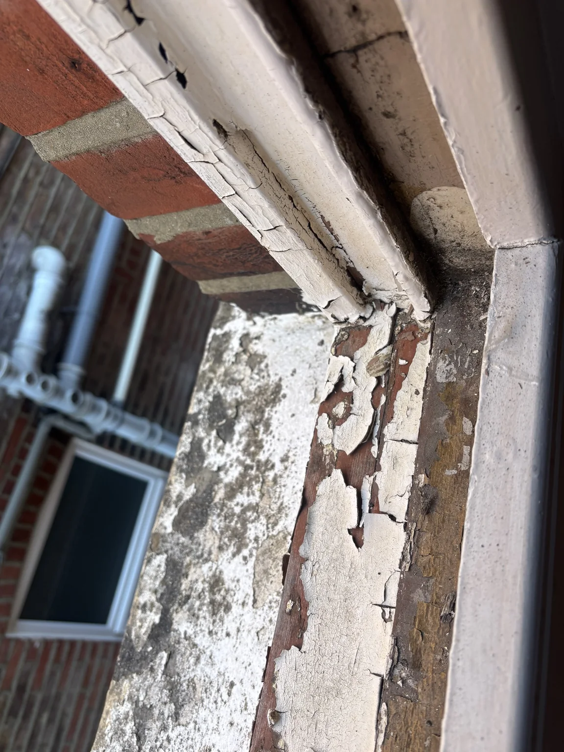Deteriorating painted timber to a traditional sliding sash window