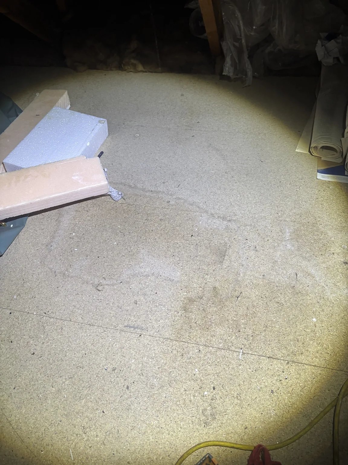 Staining to boarded loft area beneath a damaged section of roof underlay