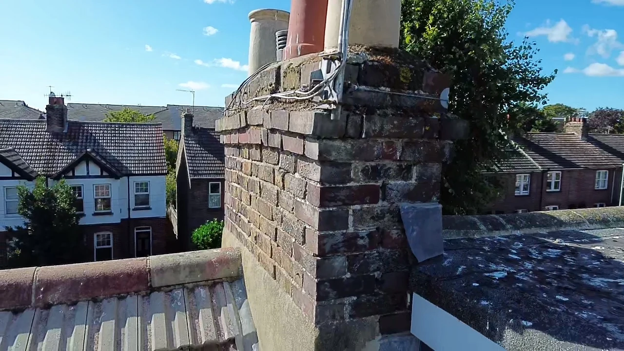 Side view of a shared chimney stack showing open pots and apparent movement to the brickwork